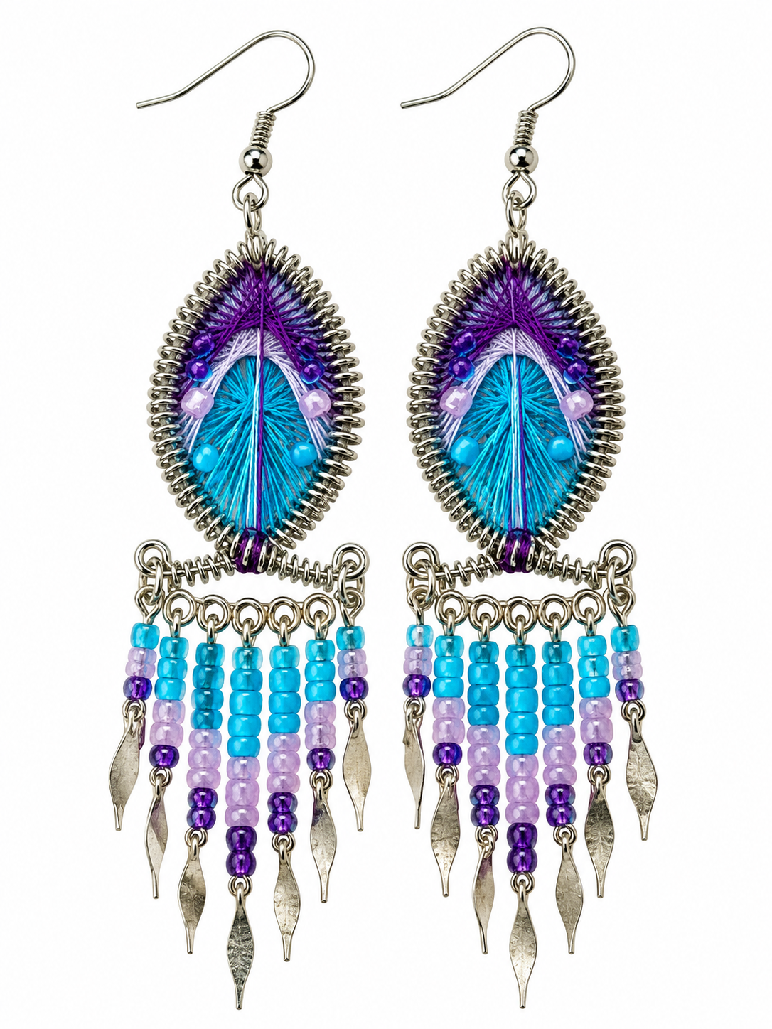 Pair of turquoise and purple teardrop threadwork fringe earrings on a white background