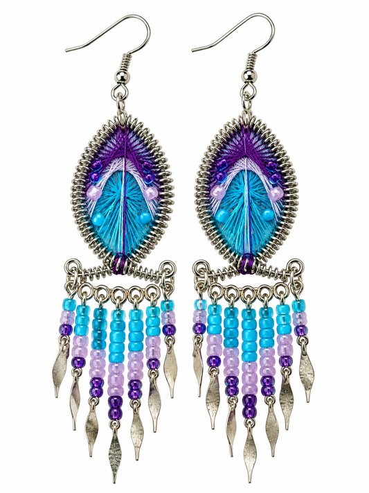 Pair of turquoise and purple teardrop threadwork fringe earrings on a white background